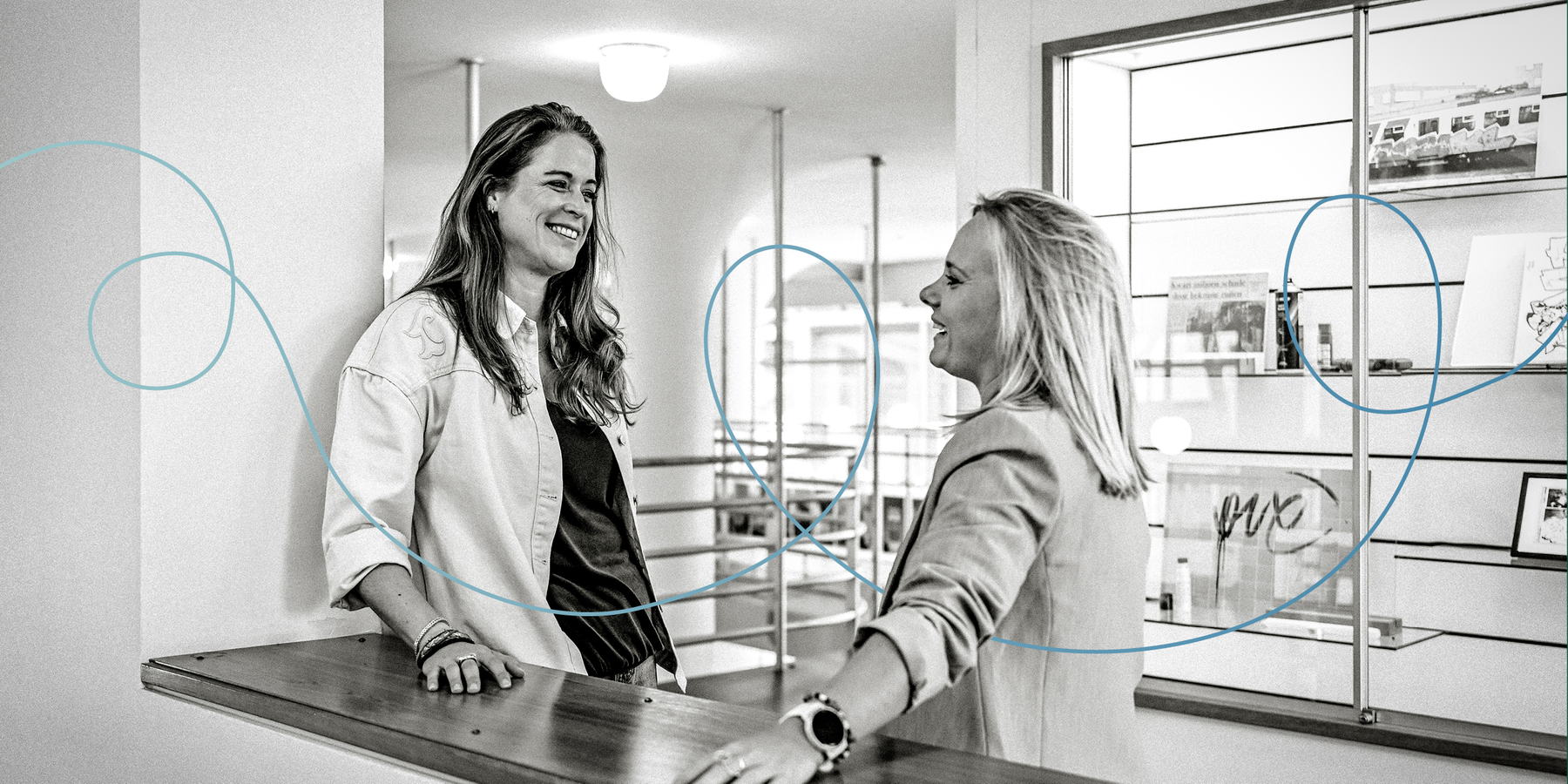 Twee vrouwen in gesprek achter een balie